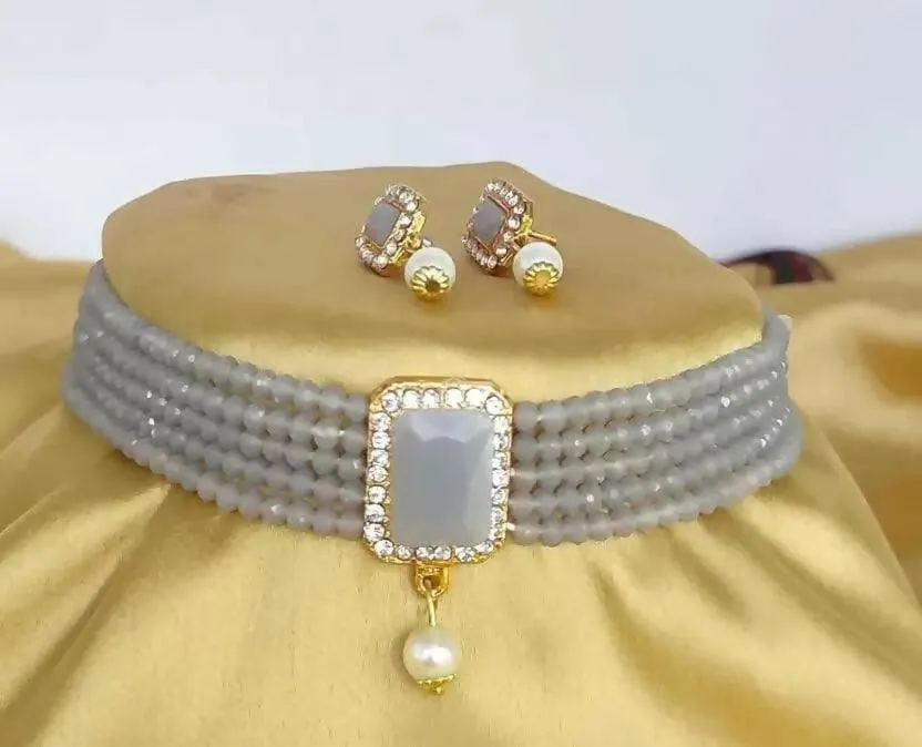 Alloy gold plated white jewel set with large blue stone | MANATH